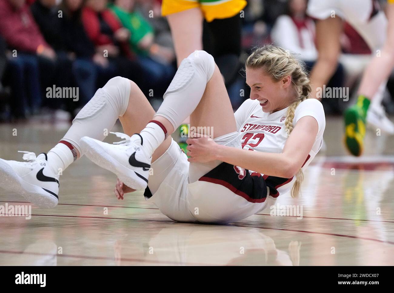 Stanford forward Cameron Brink (22) grimaces after colliding with an