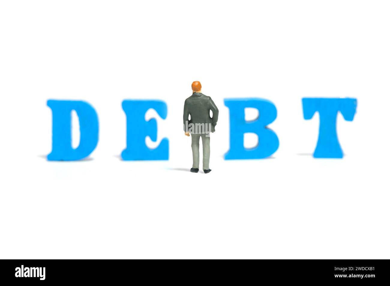 Miniature tiny people toy figure photography. A businessman looking and