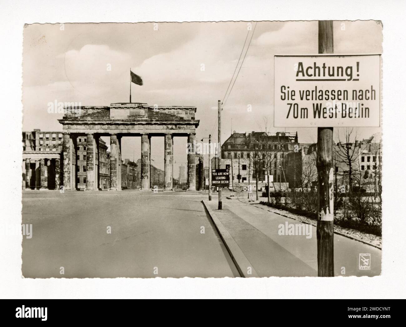 Early 1950s black and white postcard of the Brandenburg Gate, Berlin, viewed from the west, with signs warning about leaving the British Sector. Stock Photo