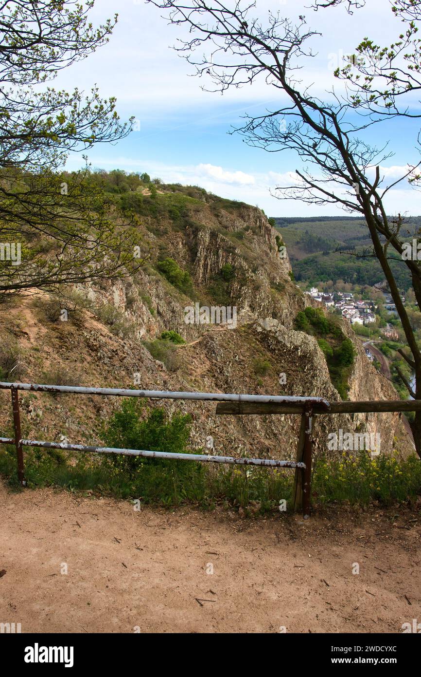 Walking path with rail at the edge of a cliff on top of Rotenfels on a spring day in Rhineland Palatinate, Germany. Stock Photo