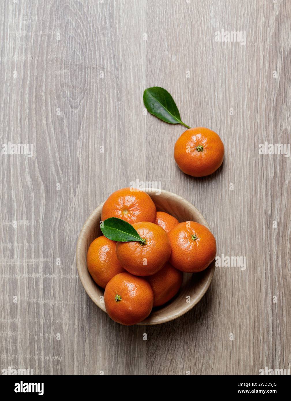mandarine tangerine group in wooden dish ripe and fresh with leaf on wooden background Stock Photo