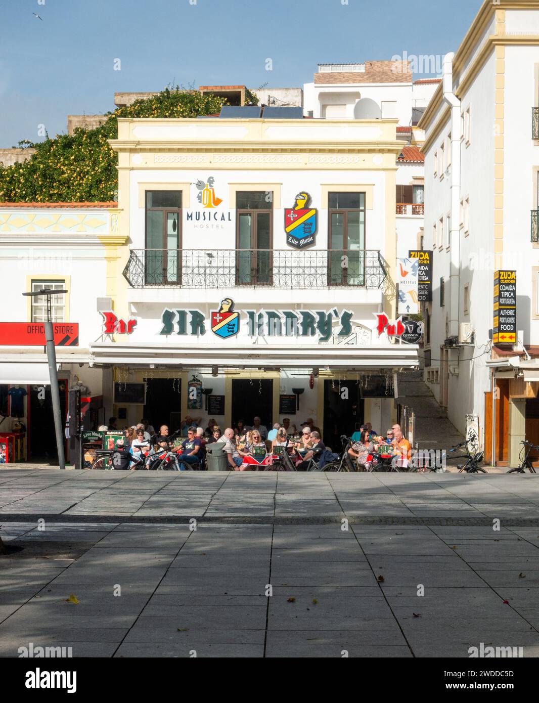 Customers Sat Outside On The Patio At Sir Harry's Bar Pub In Albufeira Old Town, Albufeira Portugal, January 14,2024 Stock Photo