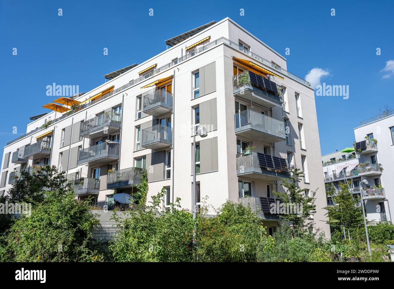 New white apartment building in front of a blue sky seen in Germany Stock Photo