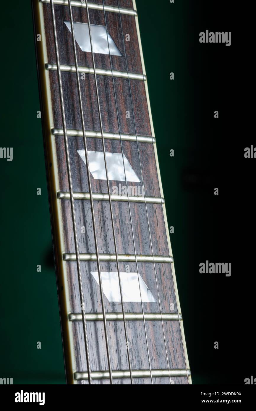 Guitar fretboard showing strings and fret markers Stock Photo Alamy
