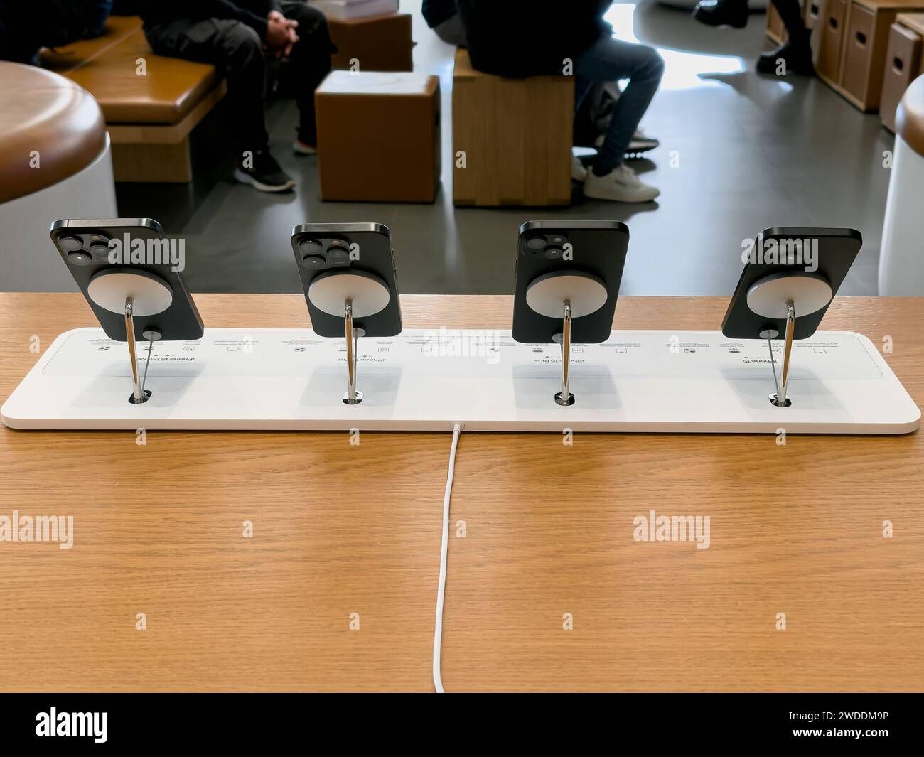 Barselona, Spain - 13.01.2024: Rear view of a series of new black Apple 15 phones on a stand where you can touch them, all 4 versions - 15, 15 Plus Stock Photo