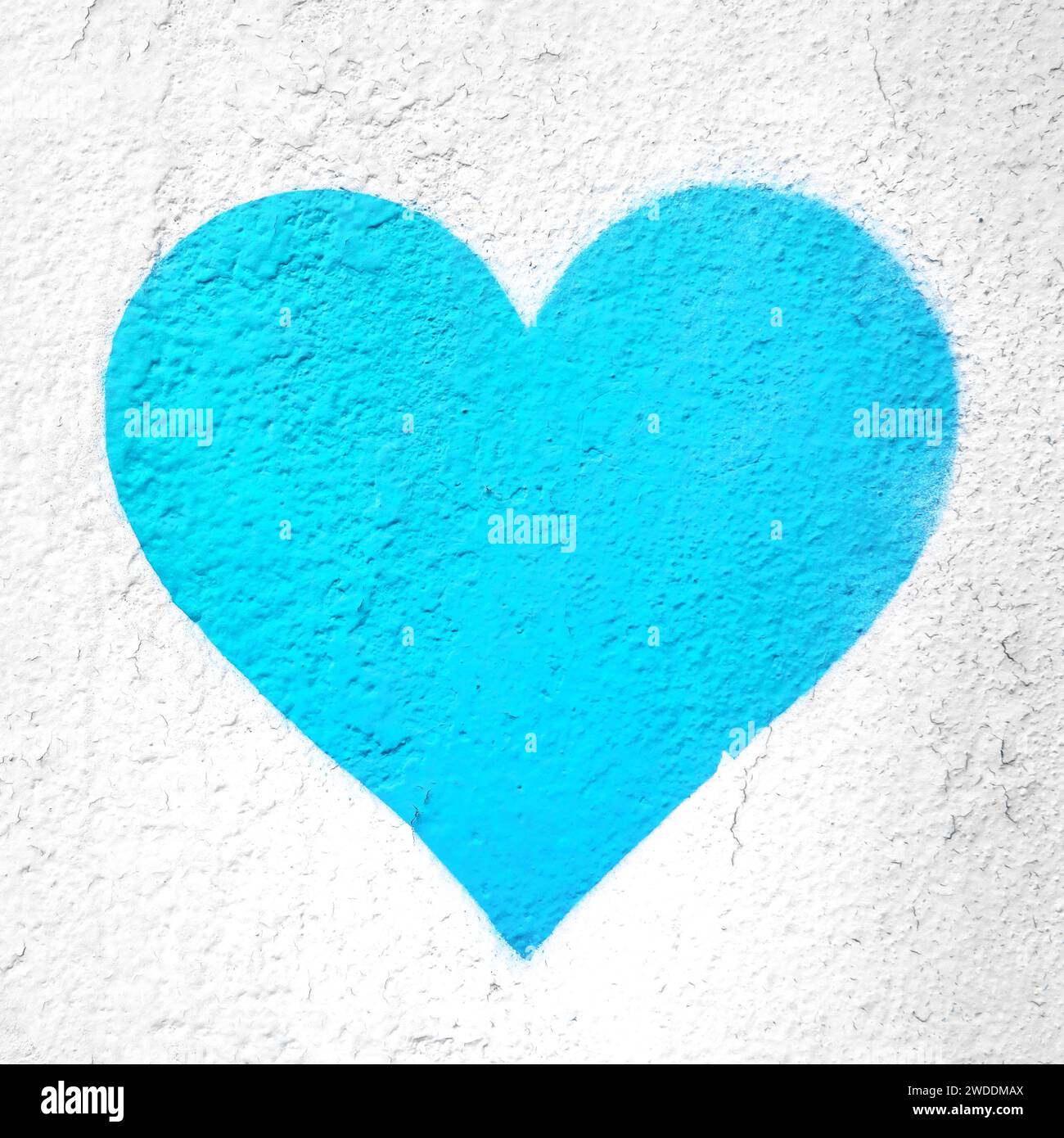 Azure heart on wall. Azure love heart hand drawn on grungy wall. Textured background trendy street style. Stock Photo