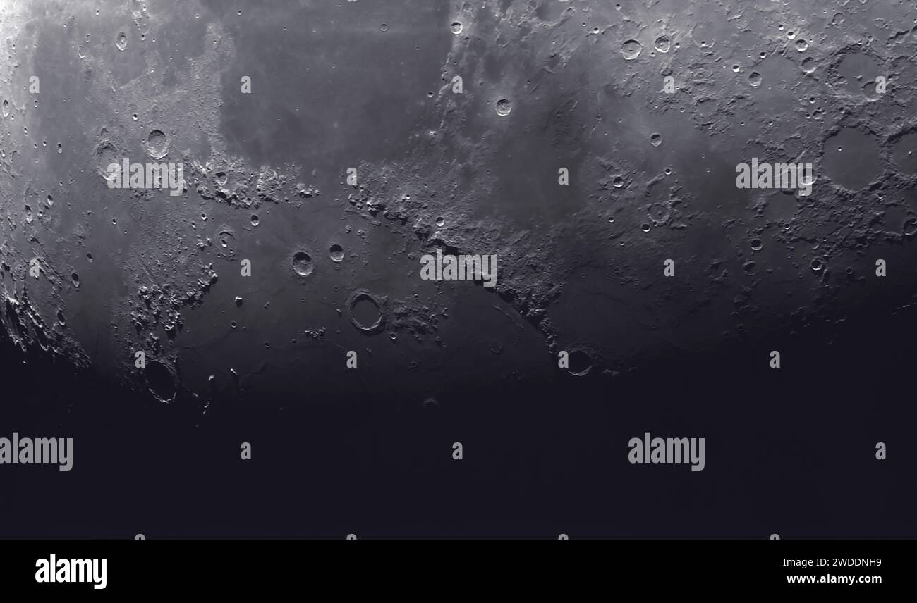 The Apennine Mountains on the Moon (centre) with the Mare Serenitatis (top left) and Mare Imbrium running into shadow (lower left) with prominent crater Archimedes Stock Photo