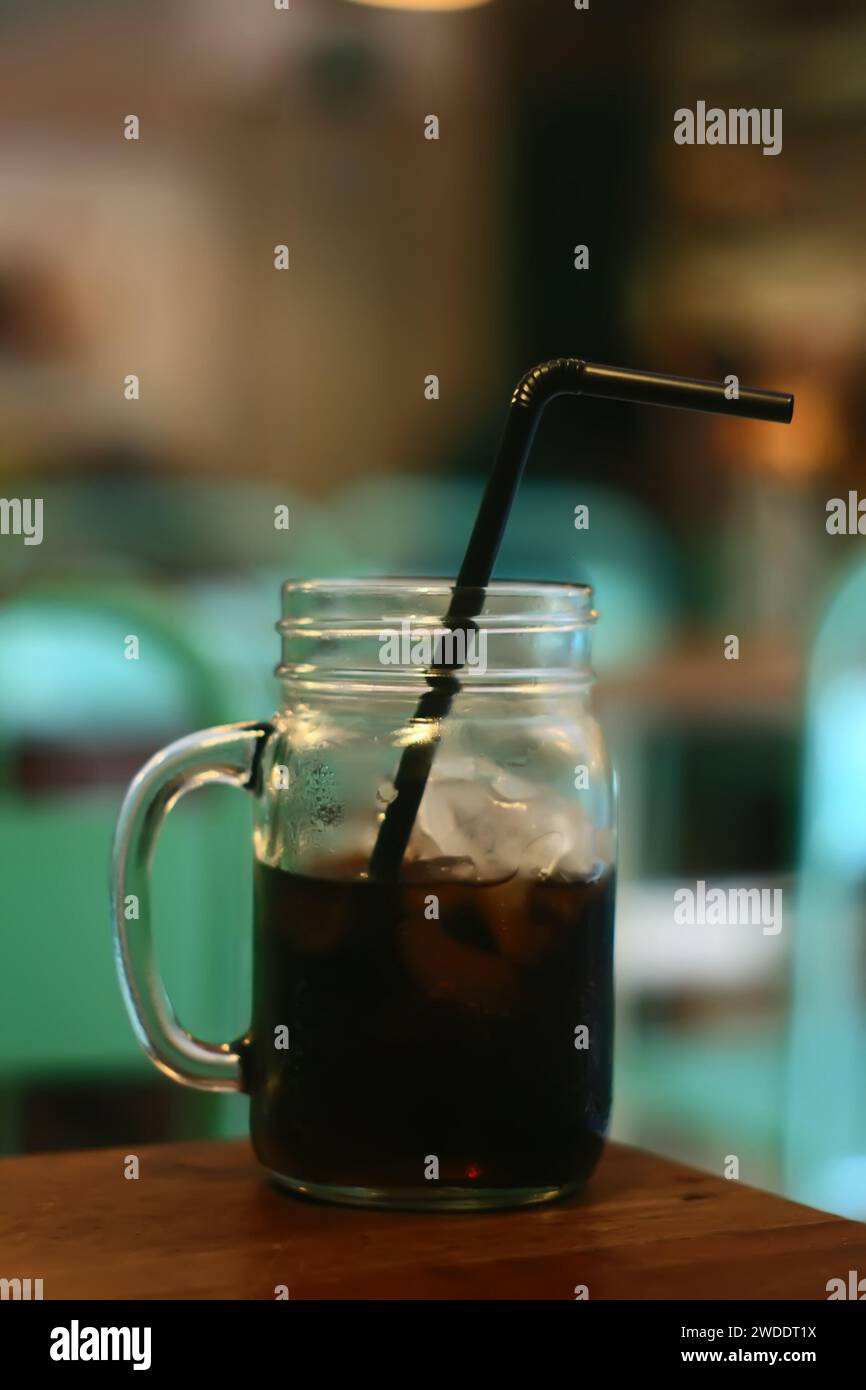 Cola in glass with ice on table of cafe bar Stock Photo