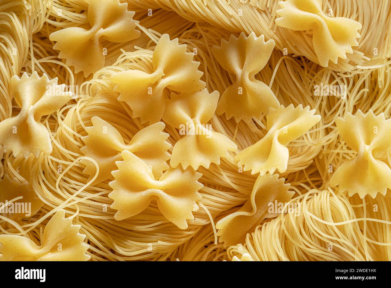 Italian pasta farfalle and vermicelli close-up. Food background. Stock Photo