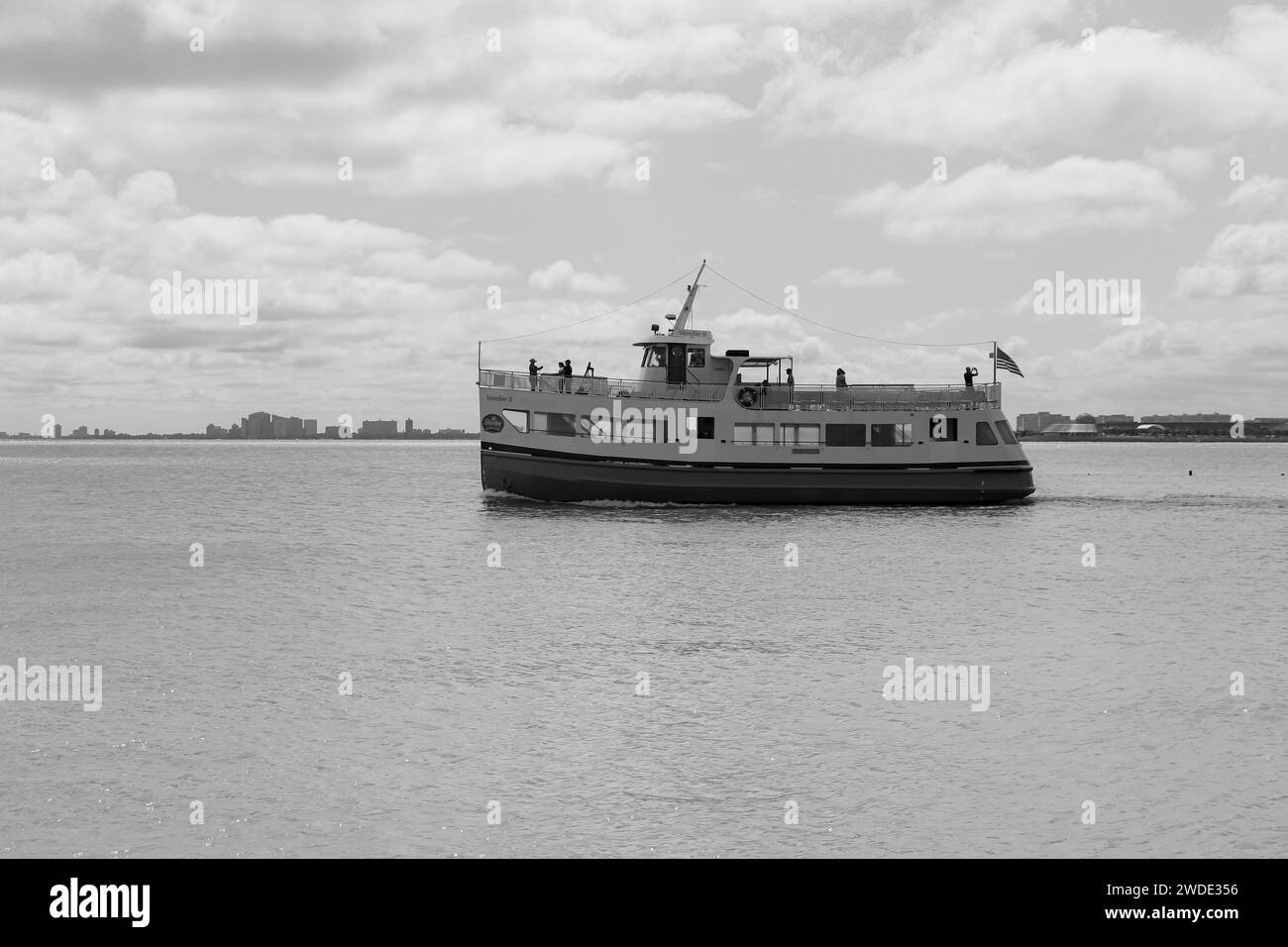 Shoreline Sightseeing water taxi, cruise boat touring Chicago’s world-famous architecture and skyline viewed from Navy Pier's waterfront boardwalk Stock Photo