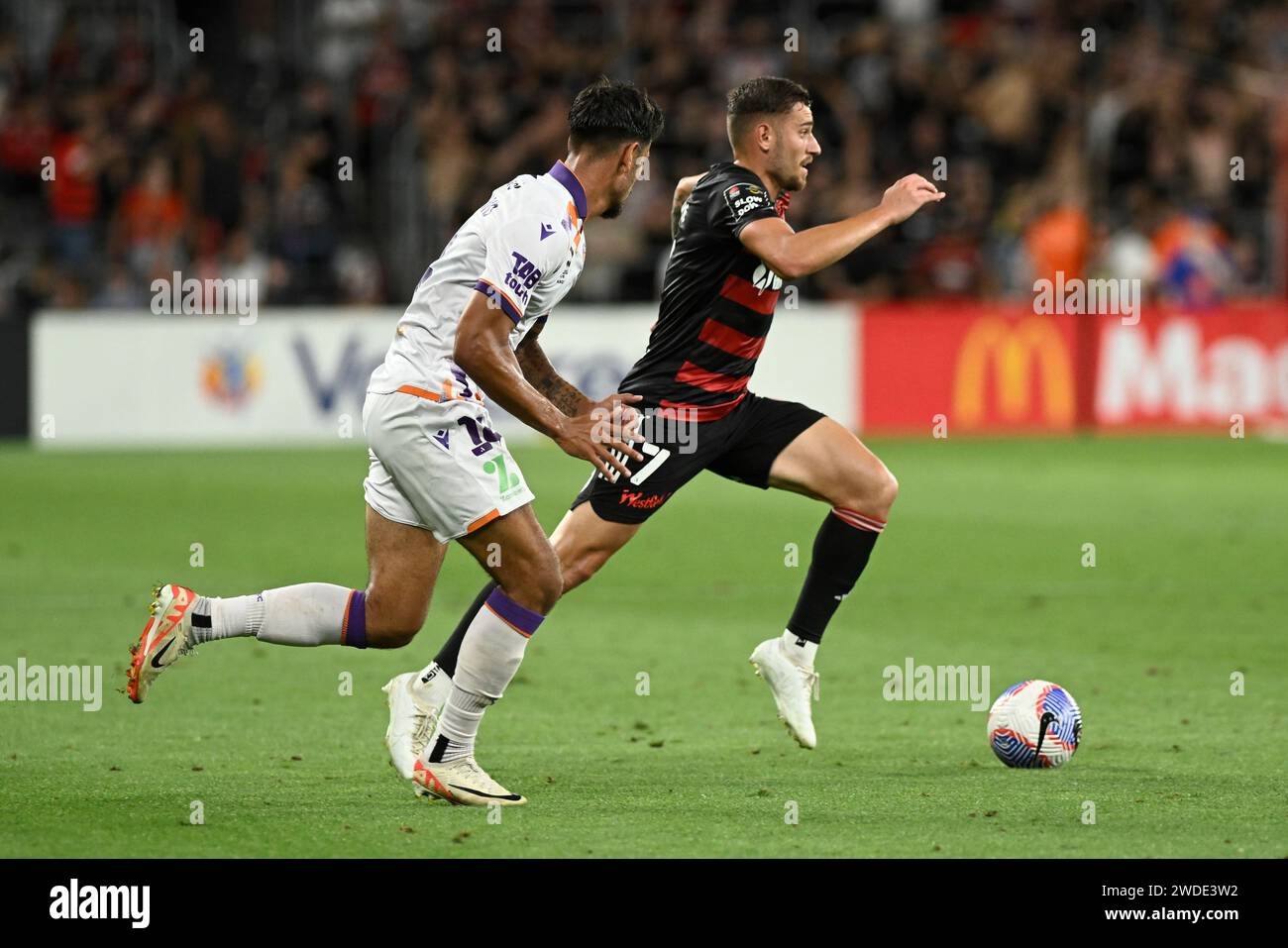 20th January 2024;  CommBank Stadium, Sydney, NSW, Australia: A-League Football, Western Sydney Wanderers versus Perth Glory; Dylan Pierias of Western Sydney Wanderers runs with the ball persued by Riley Warland of Perth Glory Stock Photo