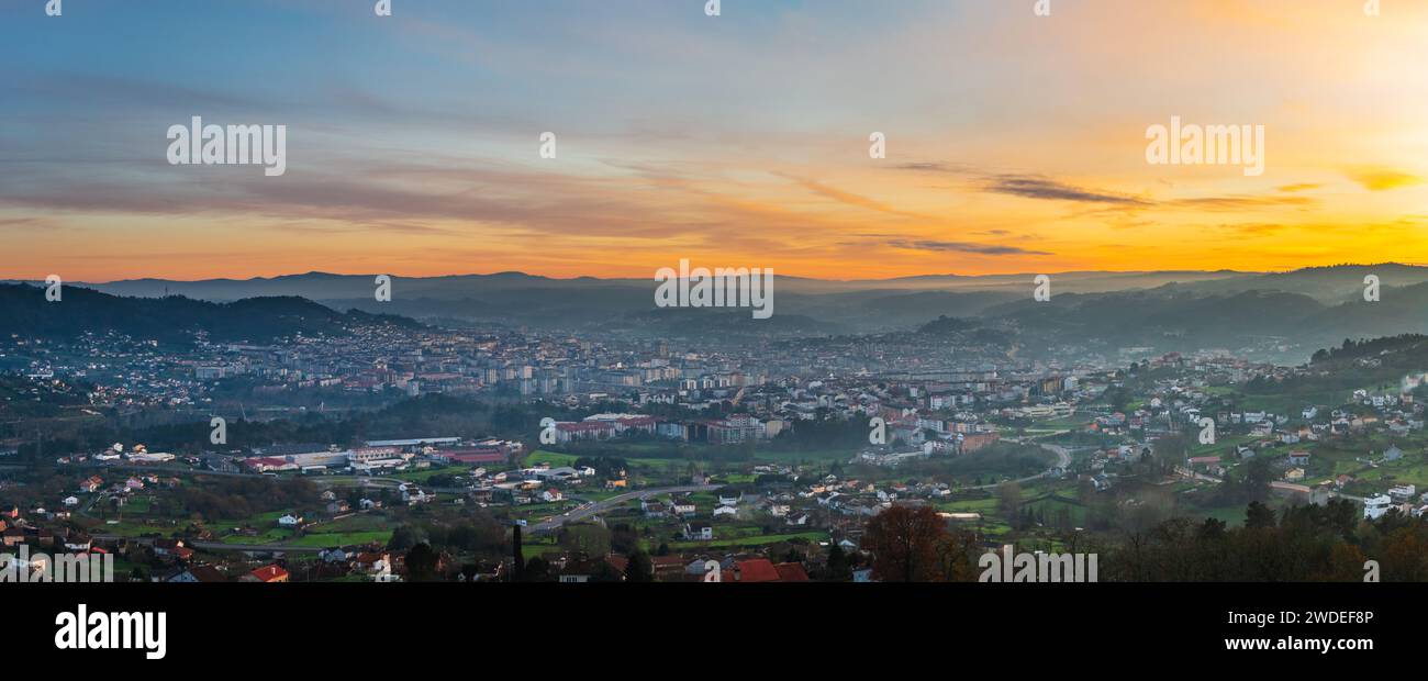 Panorama view of the skyline of the Galician city of Ourense at dusk as seen from the outskirts. Stock Photo