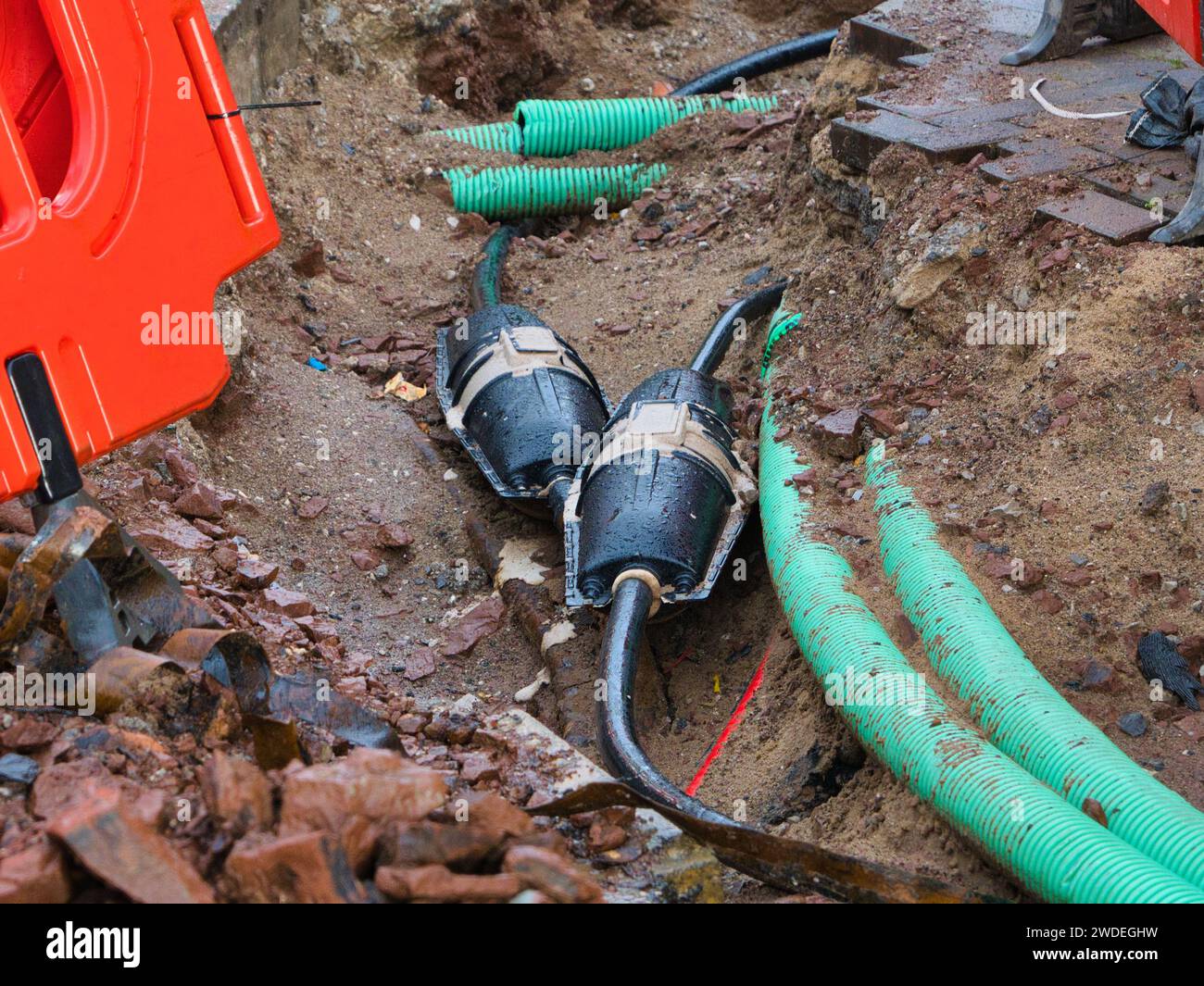 Wirral, UK - Dec 31 2023: Resin filled electrical cable connectors in an excavation in an urban area in the UK. Other utility infrastructure can be se Stock Photo