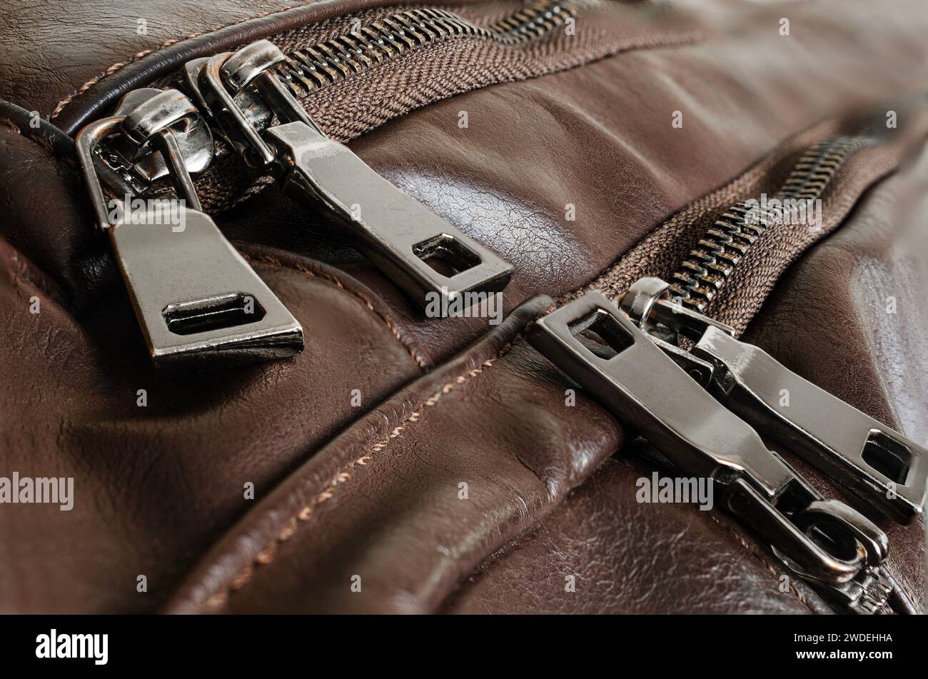 Zippers on an old leather backpack, close-up, brown Stock Photo