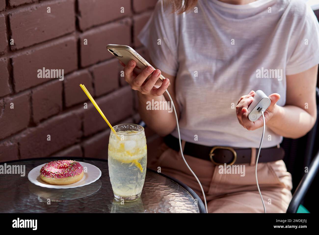 Freelancer's toolkit a powerbank in hand for uninterrupted remote work sessions Stock Photo