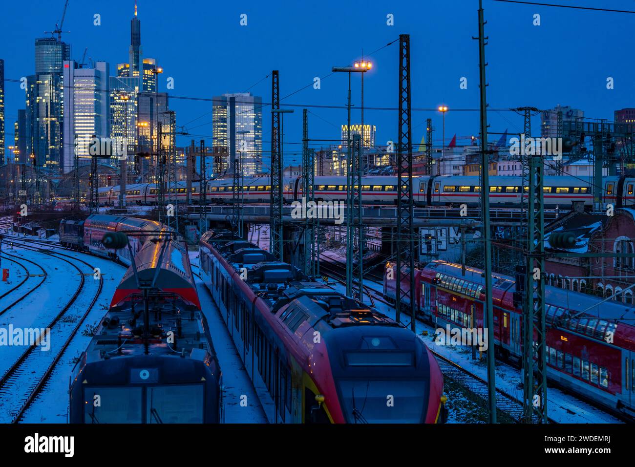 Railway tracks in front of the main station of Frankfurt am Main, ICE train, skyline of skyscrapers in the Cit, winter, snow, dusk, Hesse, NRW, Stock Photo
