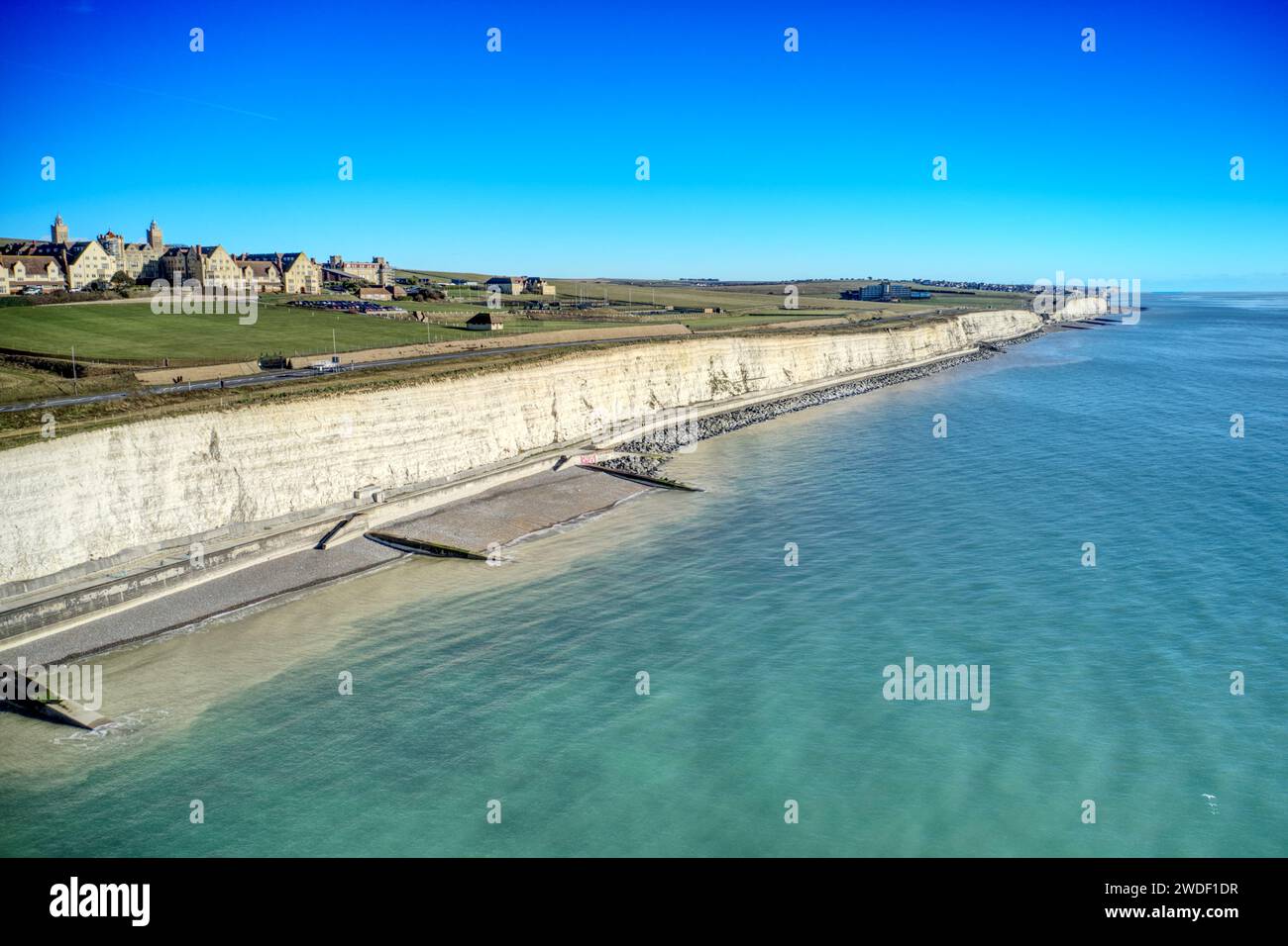 The chalk cliffs of East Sussex at Roedean near Brighton looking east towards Rottingdean, with the Roedean Girls School in view. Stock Photo