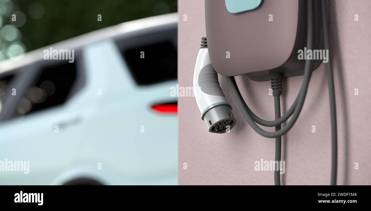 Electric vehicle charging station (wallbox) with European Type 2  IEC 62196 Plug hanging on a garage wall. Out of focus car in the background. Stock Photo