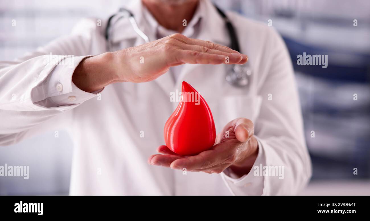Hemophilia World Day. Doctor With Donor Blood Drop Stock Photo