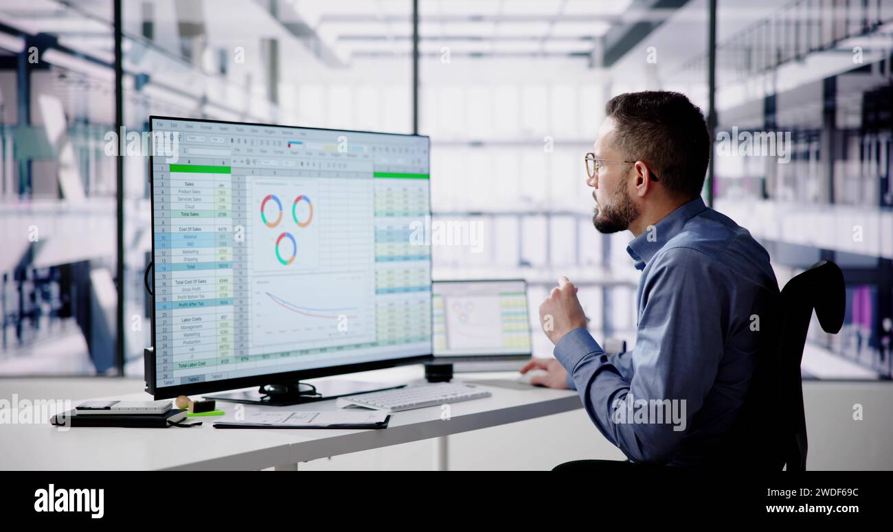 Data Analyst Man Using Spreadsheet On Computer Stock Photo
