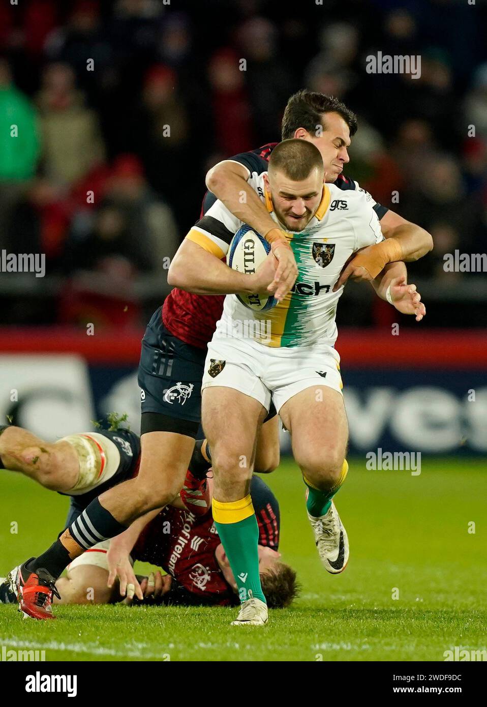 Northampton Saints' Ollie Sleightholme is tackled by Munster's Antoine