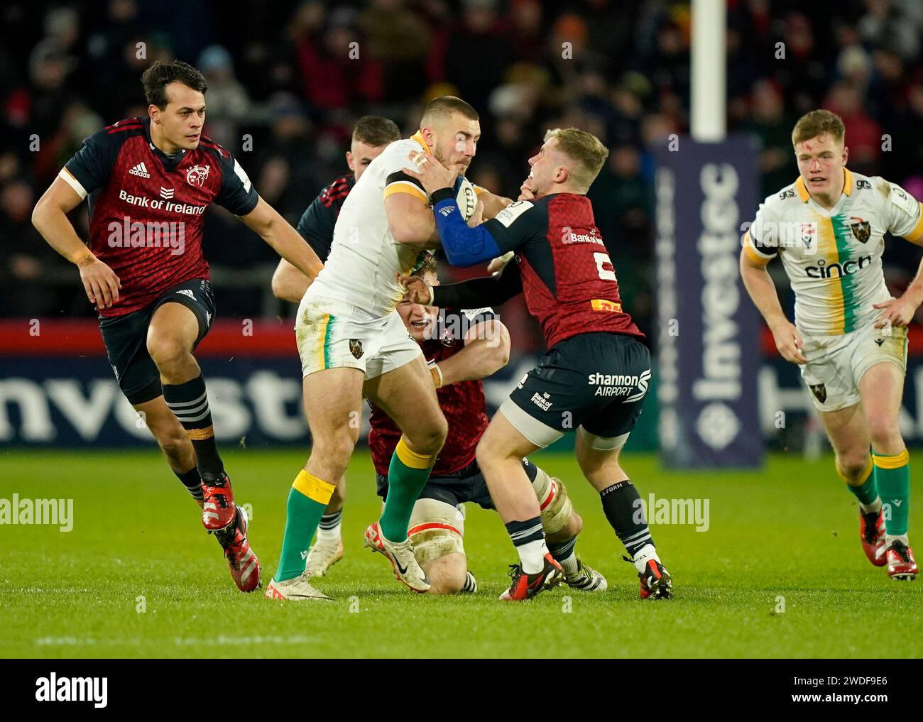 Northampton Saints' Ollie Sleightholme (left) ia tackled by Munster's