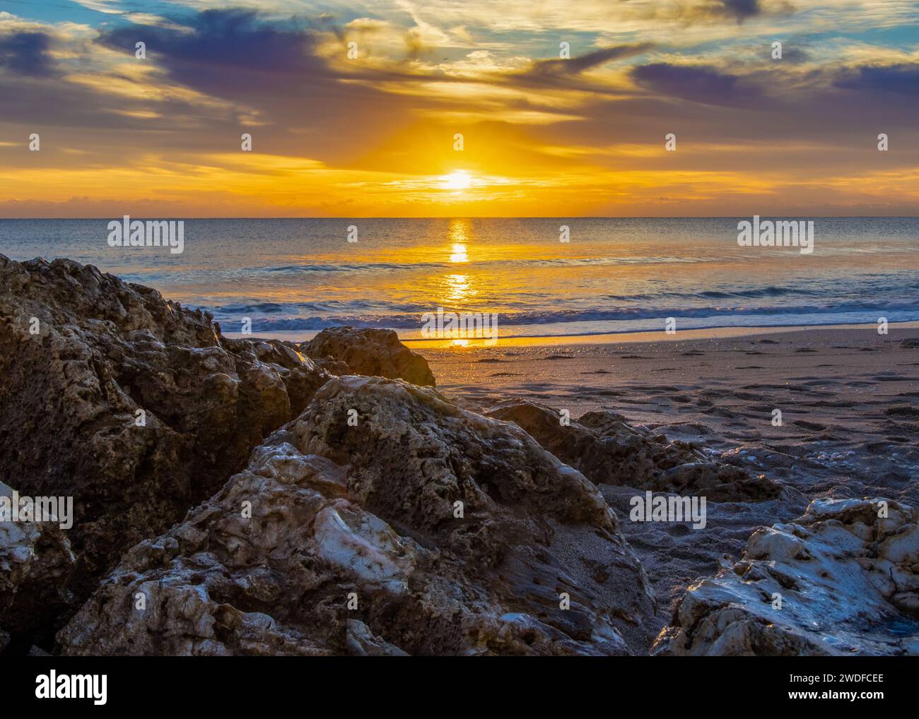 Golden sunrise over a rugged coastline, perfect for inspirational themes, travel promotion, and natural landscape photography. Stock Photo