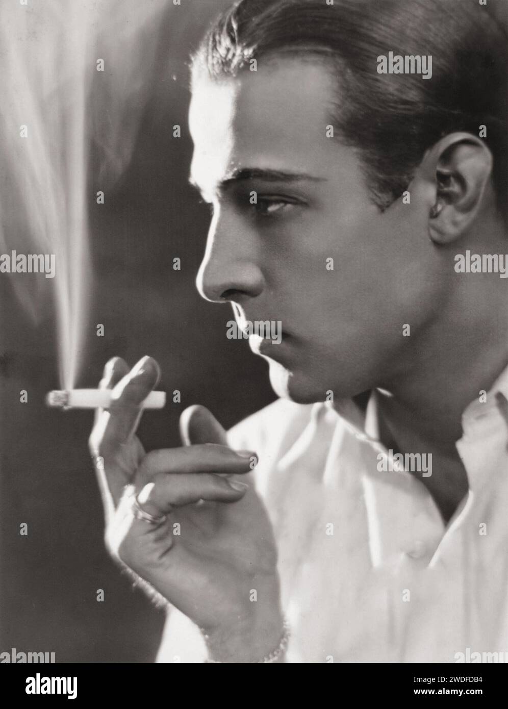 A smoking Rudolph Valentino - portrait, 1920s sepia Stock Photo