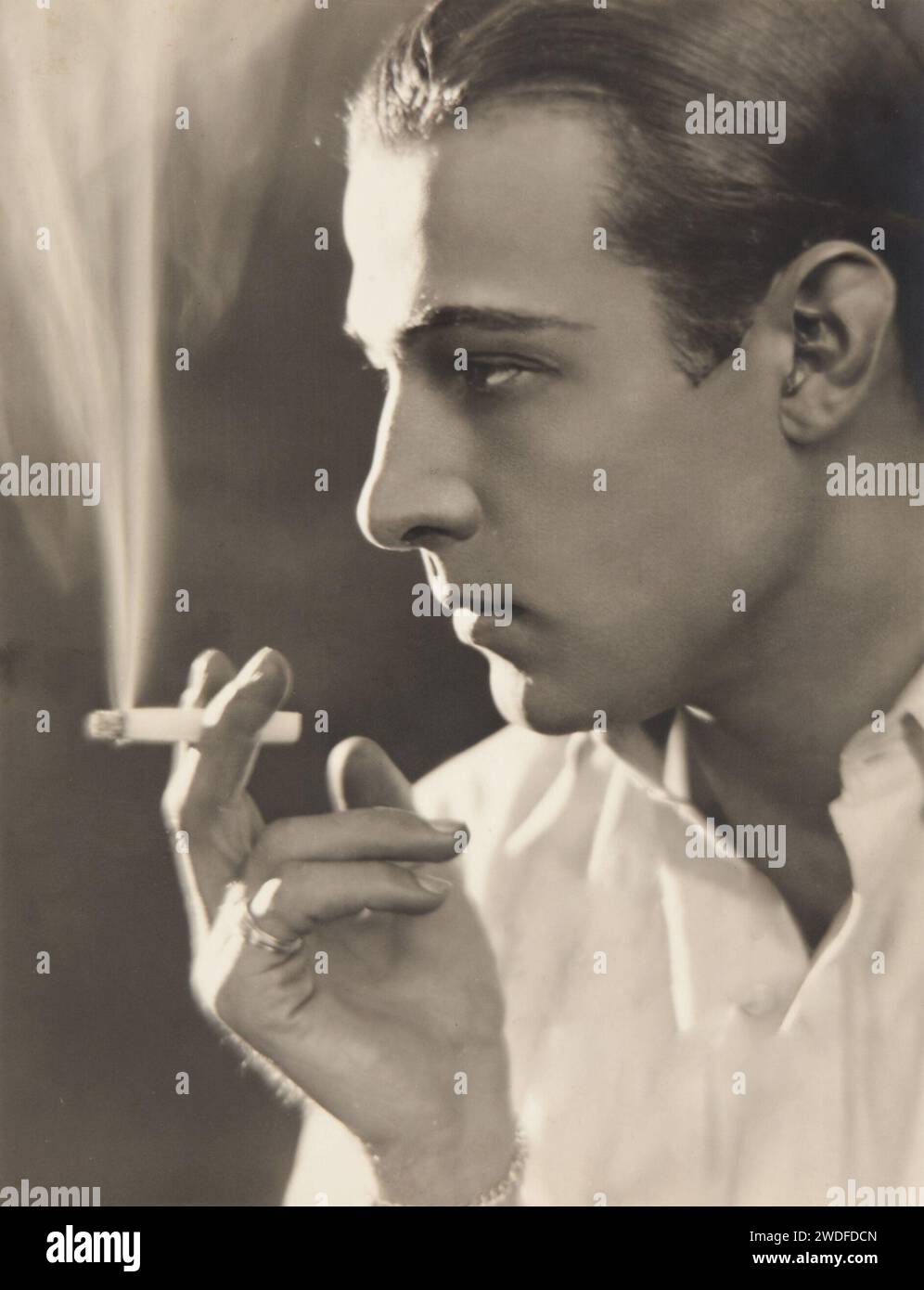 Rudolph Valentino smoking, portrait, 1920s Stock Photo