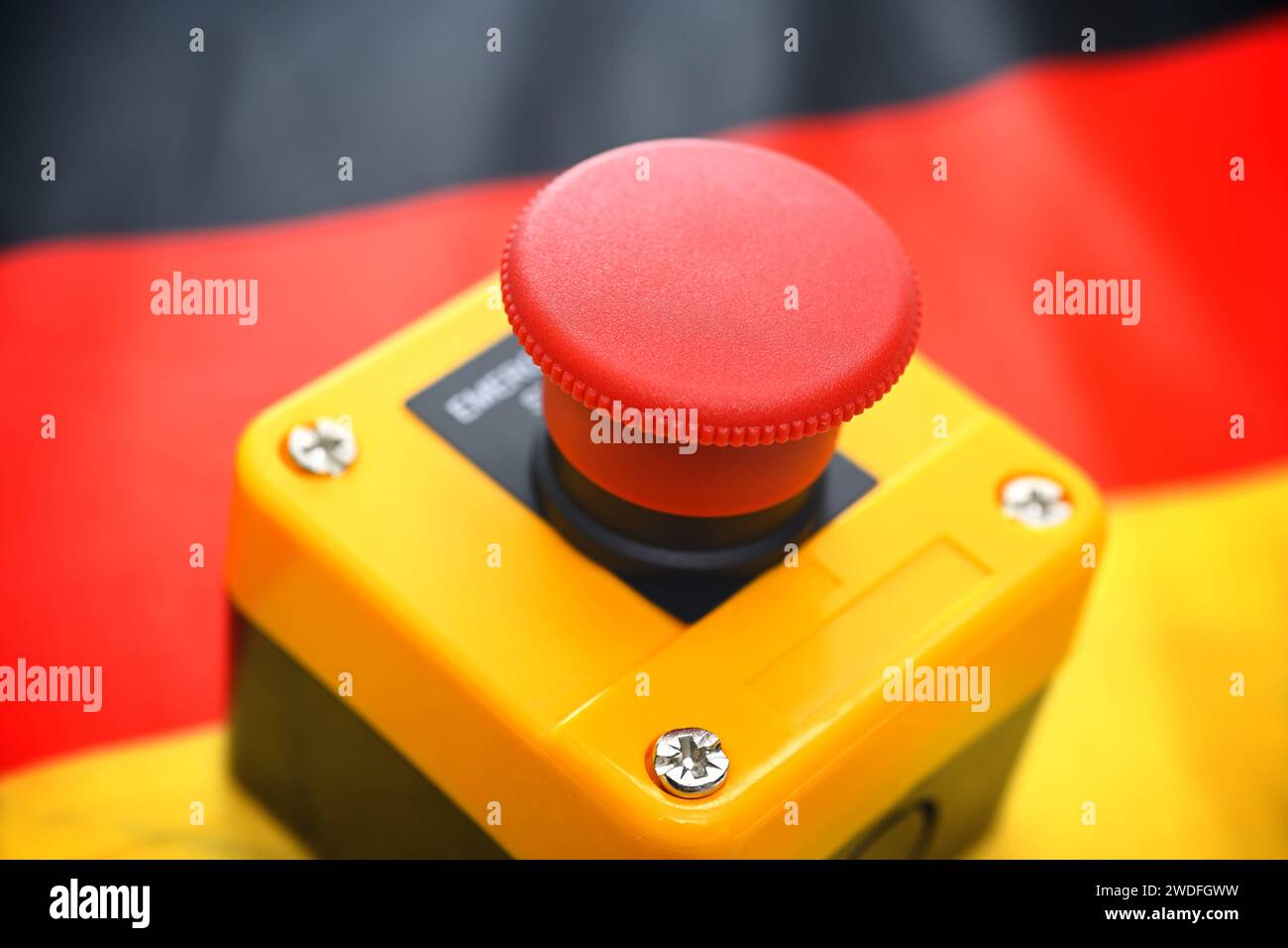 Roter Alarmknopf auf einer Deutschlandfahne *** Red alarm button on a German flag Stock Photo