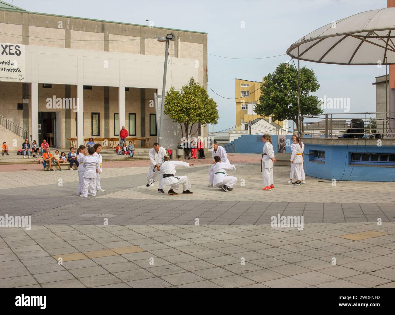 Burela, Spain - 05 05 2022: several people practicing tai jitsu in a square to promote it Stock Photo