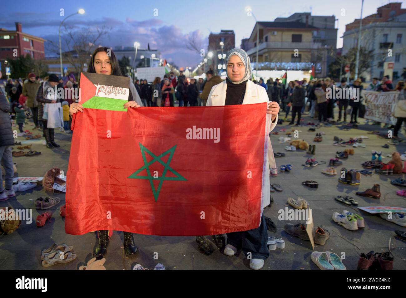 Rome Italy 20th Jan 2024 Two Girls Pose Behind A Red Flag With The   Rome Italy 20th Jan 2024 Two Girls Pose Behind A Red Flag With The Star Of David In The Center During The Flash Mob Organized By The Social Groups Of The Centocelle Neighborhood In Solidarity With The Palestinian People In Rome Many People Took Part In The Flash Mob Organized By The Centocelle Self Managed Social Laboratory And By Neighborhood Organizations In Solidarity With The Palestinian People In Rome As Has Already Happened In Various European Cities Each Participant Brought With Them Adult Andor Child Shoes As Well As Puppets To Symbolize The Dead Adults And Children Kille 2WDG4NC 