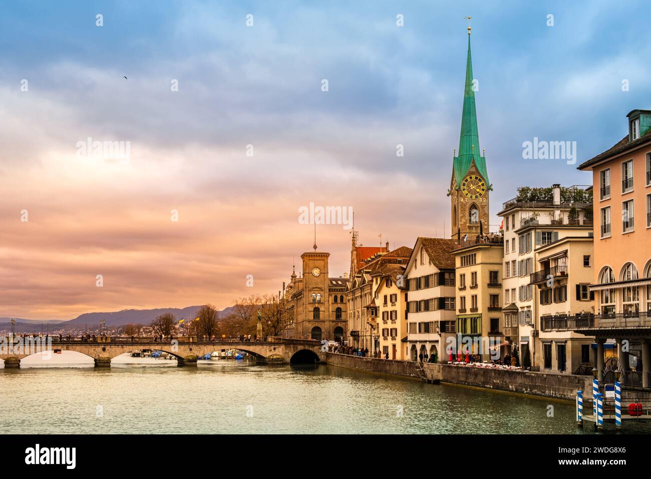 Famous Fraumunster church and Munsterbrucke bridge over river