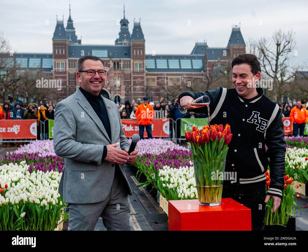 DJ/Producer, Hardwell (right) is seen baptizing with wine his own tulip, in the company of the president of the organization, Arjan Smith. Each year on the 3rd Saturday of January, the National Tulip Day is celebrated in Amsterdam. Dutch tulip growers built a huge picking garden with more than 200,000 colorful tulips at the Museumplein. Visitors are allowed to pick tulips for free.  Because this year the theme is  'Let's Dance', the international Dutch DJ/Producer 'Hardwell' was the special guest to open this event. Stock Photo