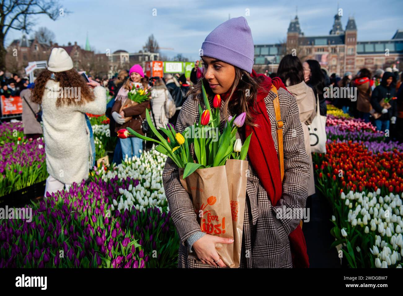 Amsterdam, Netherlands. 20th Jan, 2024. A woman is seen walking with her paper bag full of