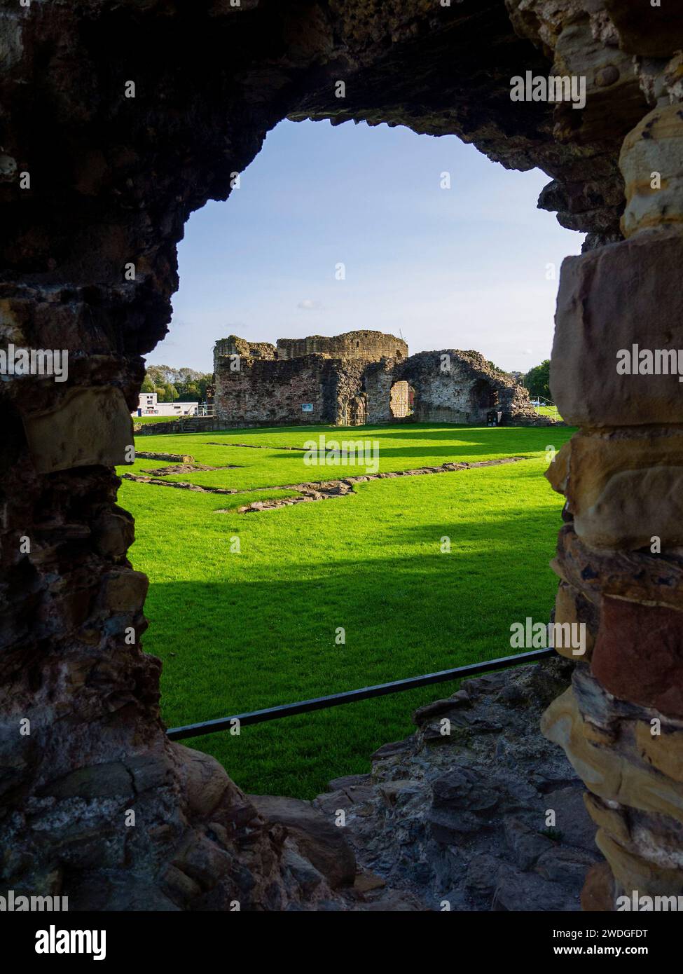 A view of Flint Castle ruins through a degraded interior arrow-slit window, Flint, Flintshire, Wales, UK Stock Photo