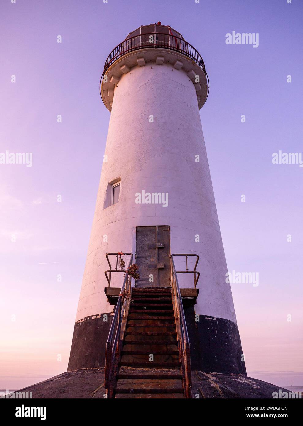 Low angle view of the entrance and staircase to the Point of Ayr Lighthouse at sunset on Talacre Beach, the northernmost point of mainland Wales, UK Stock Photo