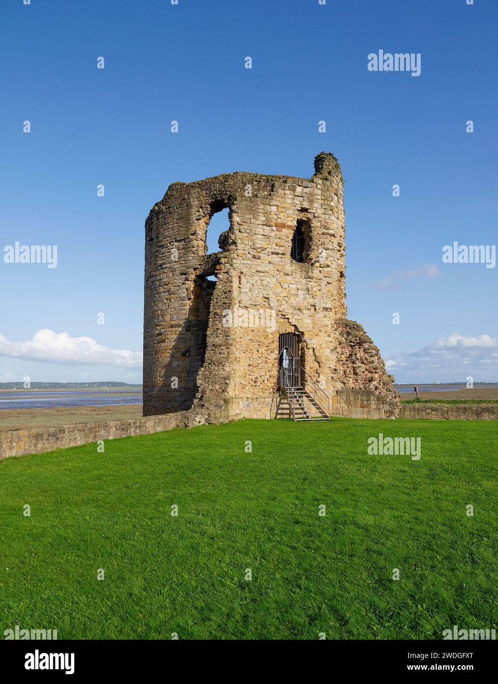 Ruined three-storey eastern corner tower of Flint Castle on a sunny day, with views across the Dee Estuary towards England, Flint, Flintshire, Wales Stock Photo