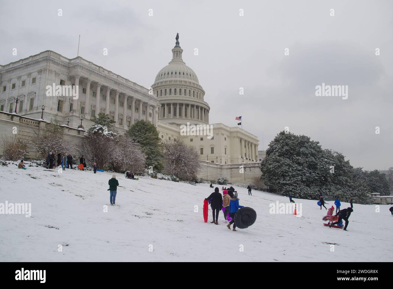 Washington, DC, USA. 19 Jan 2024. People sled on the Capitol grounds during a snowstorm. Stock Photo