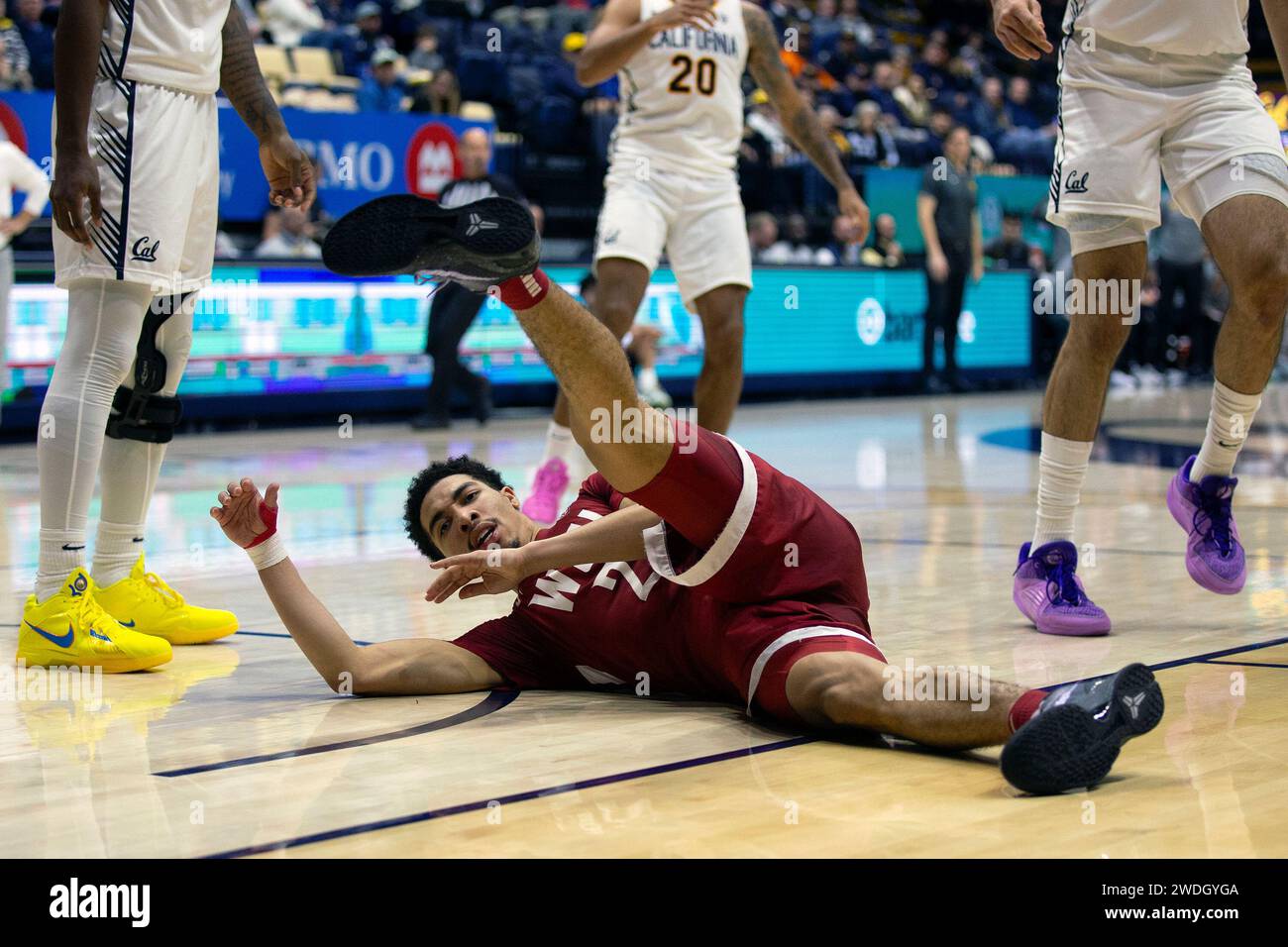 Washington State guard Myles Rice lies on the court after a hard foul