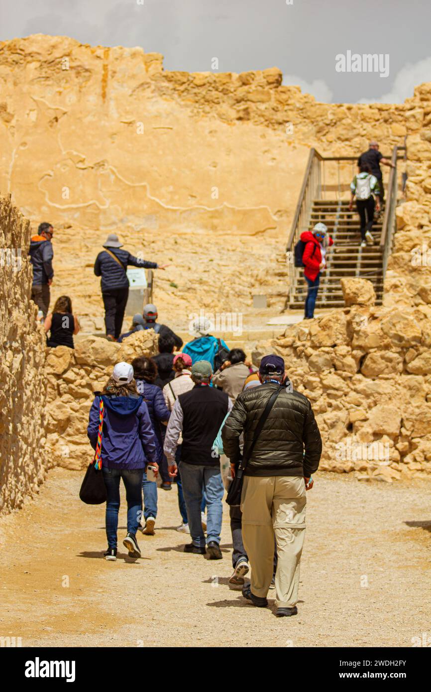 Sunny Stroll: People Walking Among the Ruins of Masada, Israel, on a Bright and Sunny Day Stock Photo