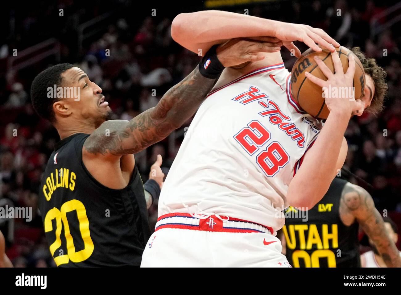 Houston Rockets center Alperen Sengun (28) pulls a rebound from Utah