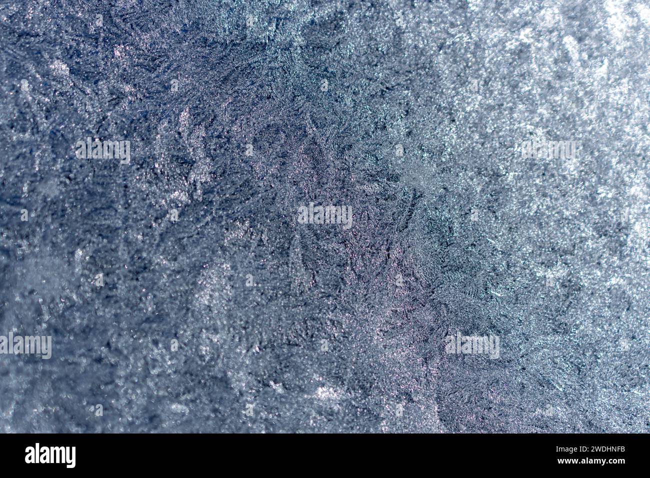 Full frame macro abstract texture background of an ice frosted glass window pane in a color shade of blue, with copy space Stock Photo