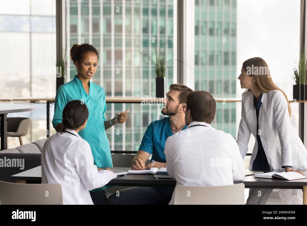 African american doctor talking colleagues hi-res stock photography and ...