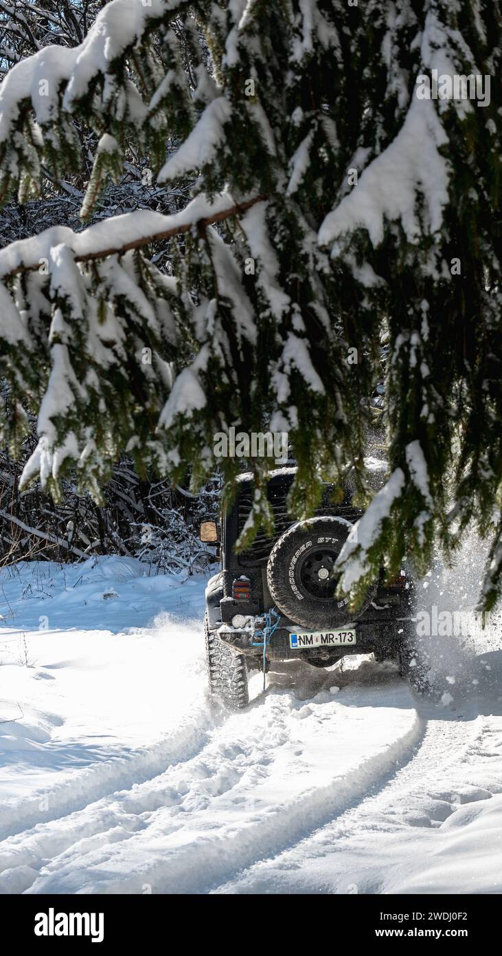 Jeep wrangler in snowy conditions offroading Stock Photo