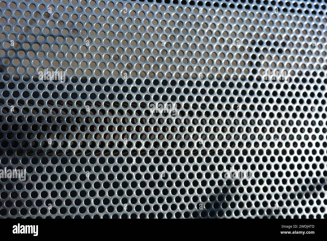 Metal mesh, background, with round identical holes, metal structure. Stock Photo