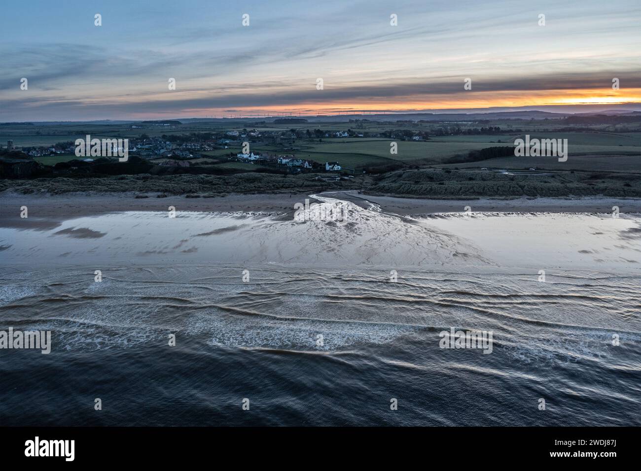 Beautiful aerial drone landscape image of Northumberland beach in Northern England during Winter sunrise Stock Photo