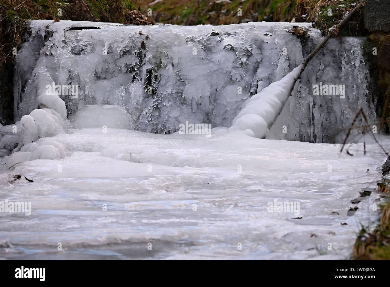 Frozen stream. Beautiful winter nature background. Frost, ice and snow in the winter. Stock Photo