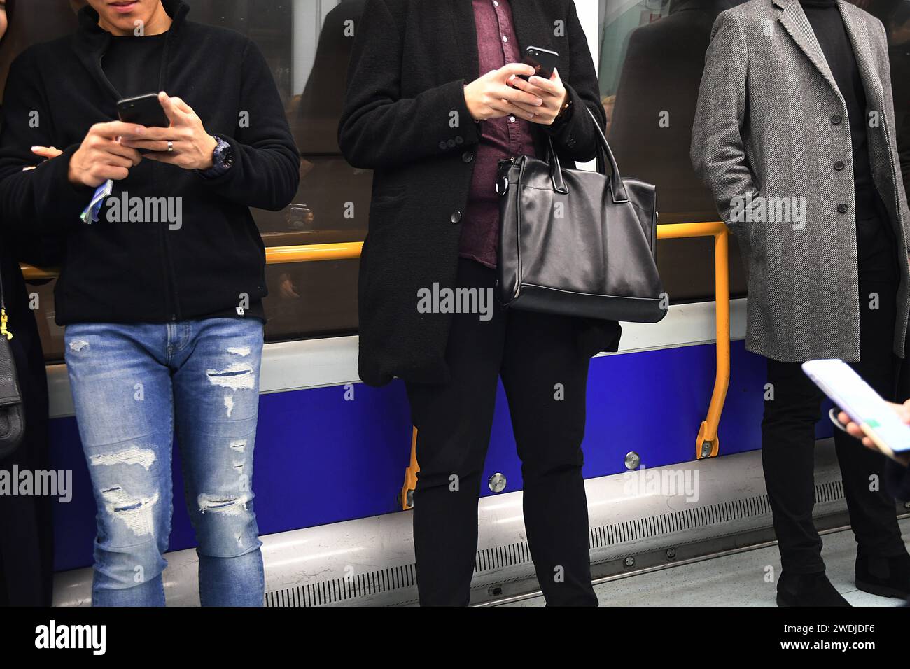 Copenhagen /Denmark/ 09.Octobert 2019/ People rea and write tex messages on smatphone and iphones and mobile during their metro train journey Photo..Francis Dean / Deanpictures. Stock Photo