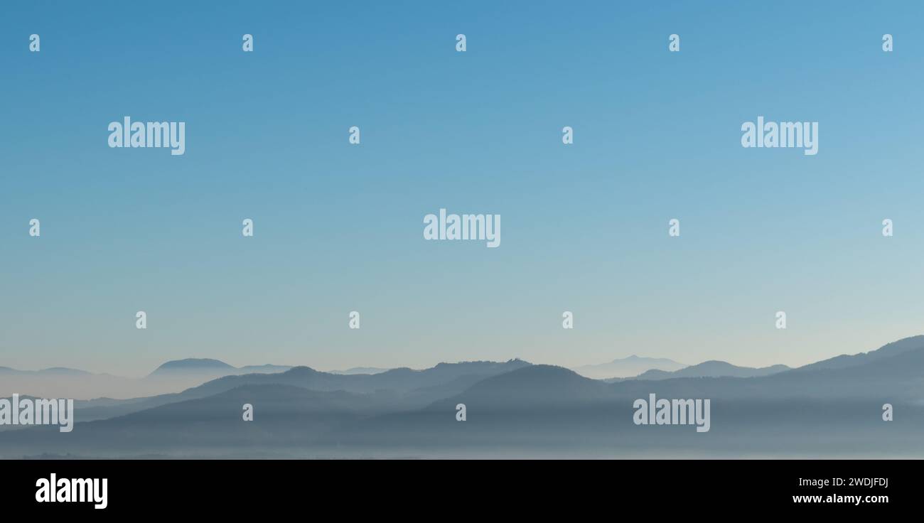 Distant hilltops in the mist, Slovenia. Stock Photo